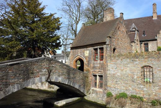 Romantic Spot in the old town Bruges - a small ancient stone Lover's Bridge crossing the canal.