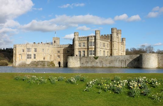 Leeds Castle in Kent, United Kingdom. Frontal view with blooming daffodils.