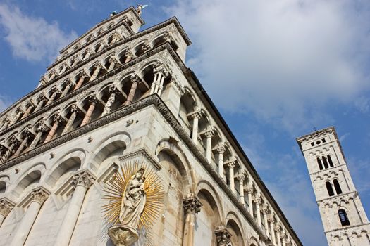 Basilica San Michele in Foro with the famous statue of Madonna salutis portus at the corner of the facade.