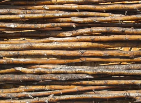 Background of an Old fence made from bended wooden sticks.