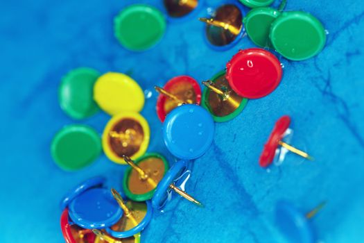 Extremely close-up photo of the wet pushpins on a blur background. Horizontal image with shallow depth of field for natural view