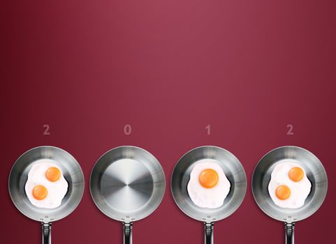 Happy new year 2012, conceptual images Fried eggs in a frying pans creating 2012 year number.