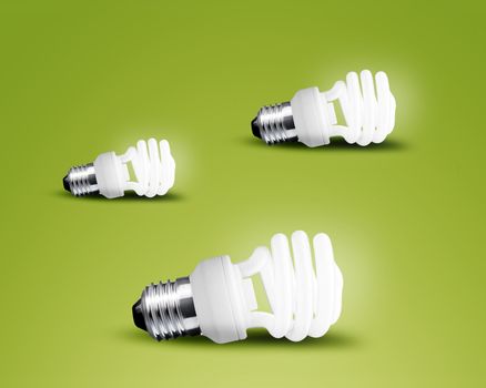 Three glowing Light bulb idea on green background