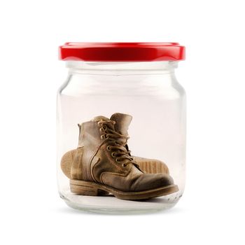 Pair of boots closed in a jar on white background