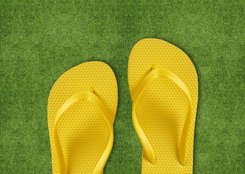 Yellow Flip Flops on green grass, summertime