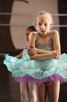 Cute shivering mulatto child in ballet dress
