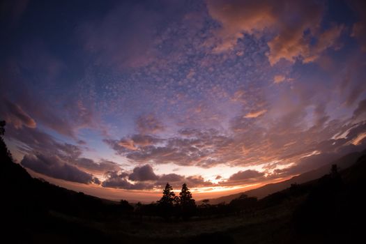 Fisheye lens scene of sunset and clouds outside