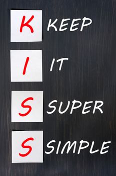 KISS acronym for keep it super simple written on a blackboard 