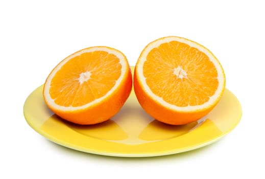 Orange cut in half on plate.
