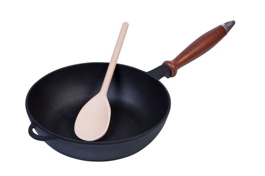 Frying pan on white background with wooden spoon inside.