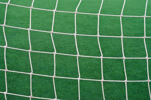 Goal soccer net background grass football field.