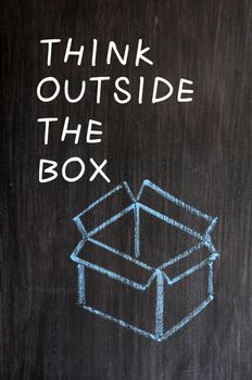 Concept of "Think outside the box" drawn with chalk on a blackboard 