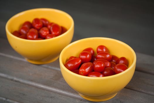 Small cherry tomatoes in yellow bowl