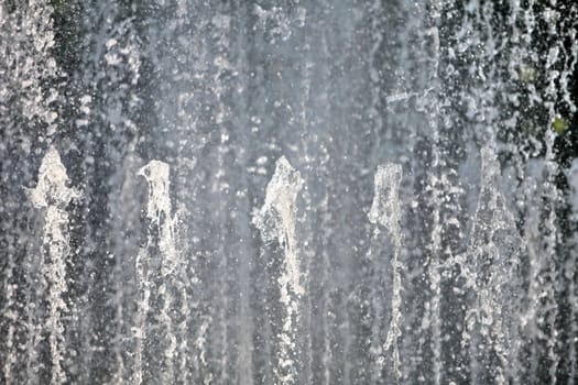 Water wall fountains from spouting vertical background, close-up