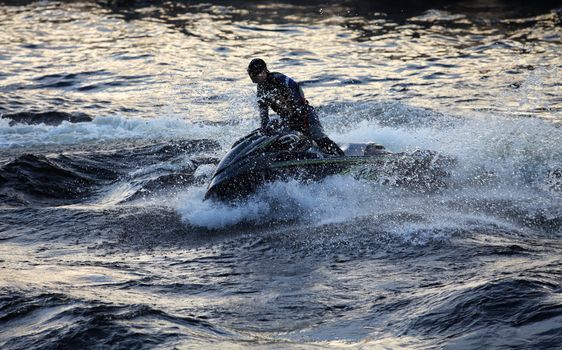 jet ski at high speed lifts a large wave