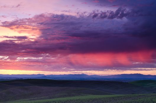 Storm clouds at sunrise and the distant Clearwater Mountains, Latah County, Idaho, USA