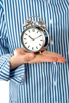 Boys palm holding alarm clock. Focus on clock