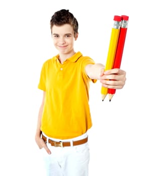 Stylish boy showing two large pencils, red and yellow