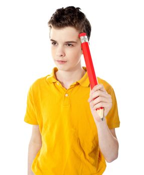 Thoughtful boy holding a pencil isolated on a white background