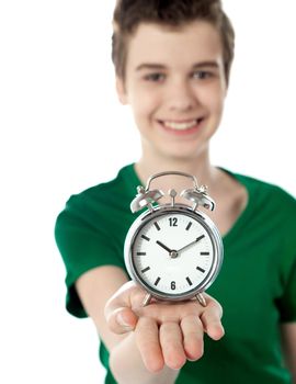 Adorable boy with a alarm clock isolated on white background