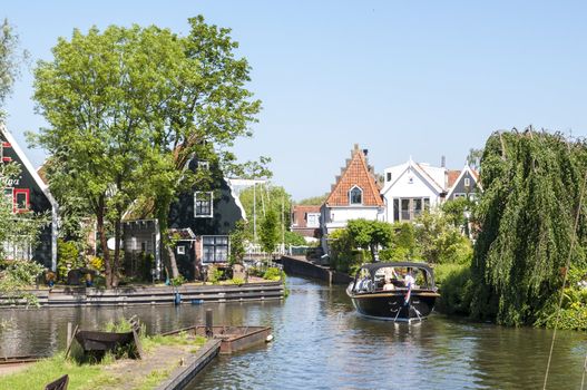EDAM, HOLLAND - MAY 28: Detail of one of the canal that cross the city, with private boat. May 28, 2012 in Edam.