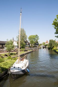 EDAM, HOLLAND - MAY 28: Detail of one of the canal that cross the city, with private boat. May 28, 2012 in Edam.