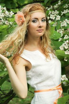 Romantic red-headed woman in flower blossom