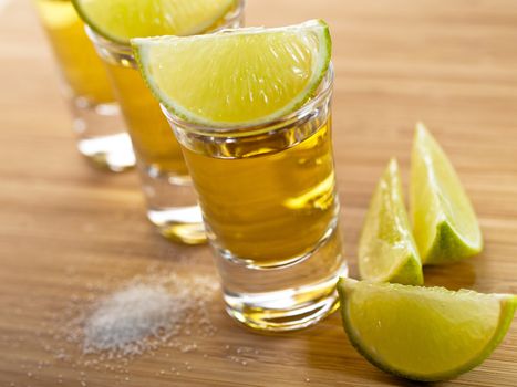 Three shots of tequila with lime and salt