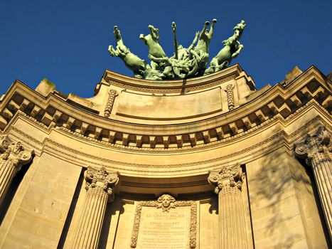A monumental bronze quadriga at The Grand Palais des Champs-Elysees facade.