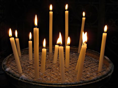 Candles lit for prayer in papal Basilica di Santa Maria in Trastevere
