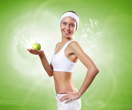 Portrait of a young woman doing sport with a green apple