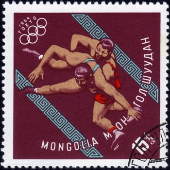 MONGOLIA - CIRCA 1964: A stamp printed in MONGOLIA shows wrestling with the inscription "Tokyo, 1964", series "XVIII Summer Olympic Games, Tokyo, 1964", circa 1964