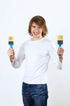 Portrait of young man with paint brushes