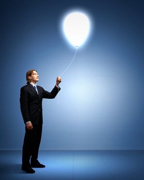 Light bulb and a business person as symbols of creativity in business