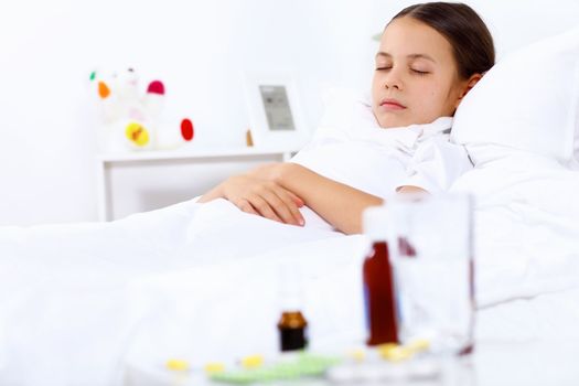 Little girl with illness at bed at home