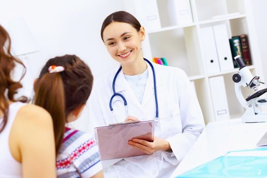 Little girl and young doctor in hospital having examination