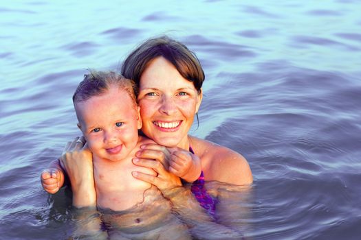 mother and son swim in the sea