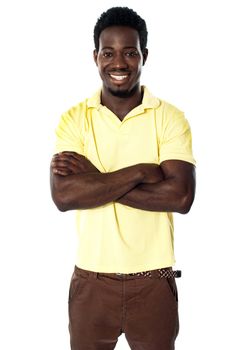Handsome young african male posing with folded arms. Smiling at camera