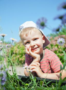 Small boy lying on the grass