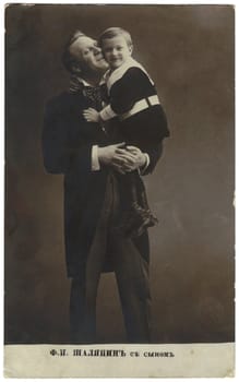 pre-revolutionary Russia - CIRCA 1911: a postcard printed in Russia showing Feodor Chaliapin (1873-1938) great Russian opera singer (bass) and her son in her arms, circa 1911