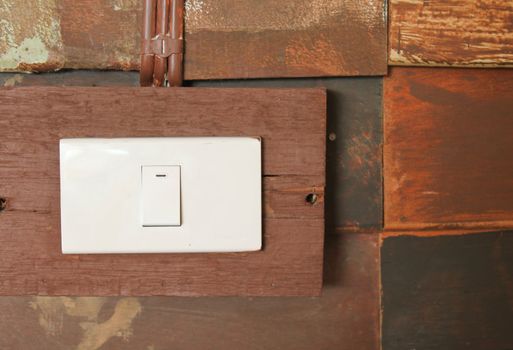 Switch button on grunge wooden wall