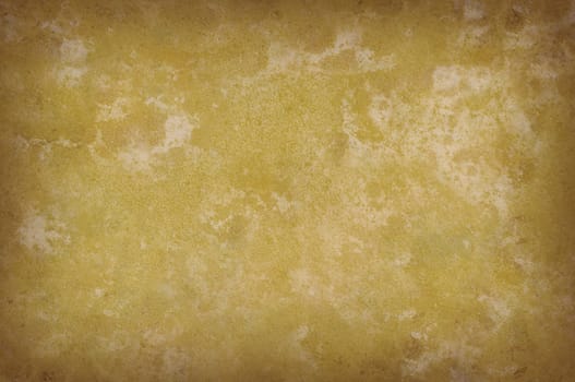 Grungy yellowish mottled background surface texture