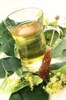 a cup of lime blossom tea with fresh flowers