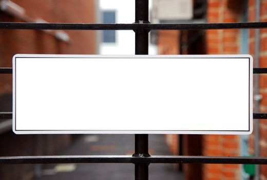empty sign hanging on a metallic gate (isolated on white, copy-space available for design)