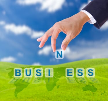 business man hand and business word on blue sky