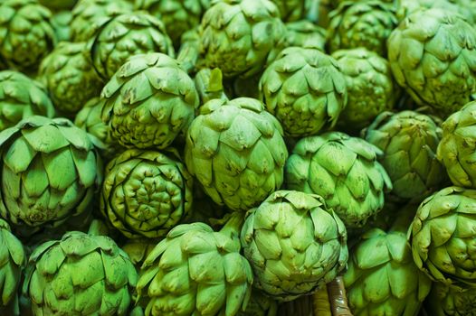 Fresh green artichokes on a farm stand