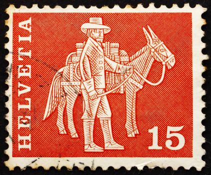 SWITZERLAND - CIRCA 1960: a stamp printed in the Switzerland shows Messenger and Pack Animal, circa 1960