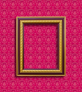 frame of golden wood  on pink wallpaper