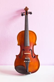 violin on pink wall