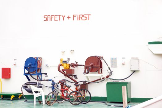 Safety First inscription on the wall and two bikes parked near the pressure pump. Industrial site